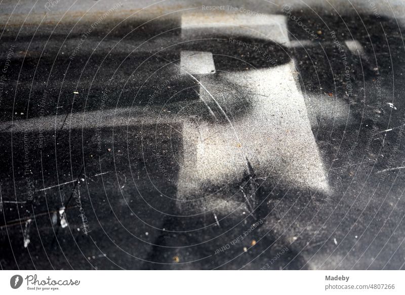 Geometric figures and stencils in black and shades of grey as residues of spray cans on a surface in front of an old workshop in the Margaretenhütte district of Gießen on the Lahn in Hesse