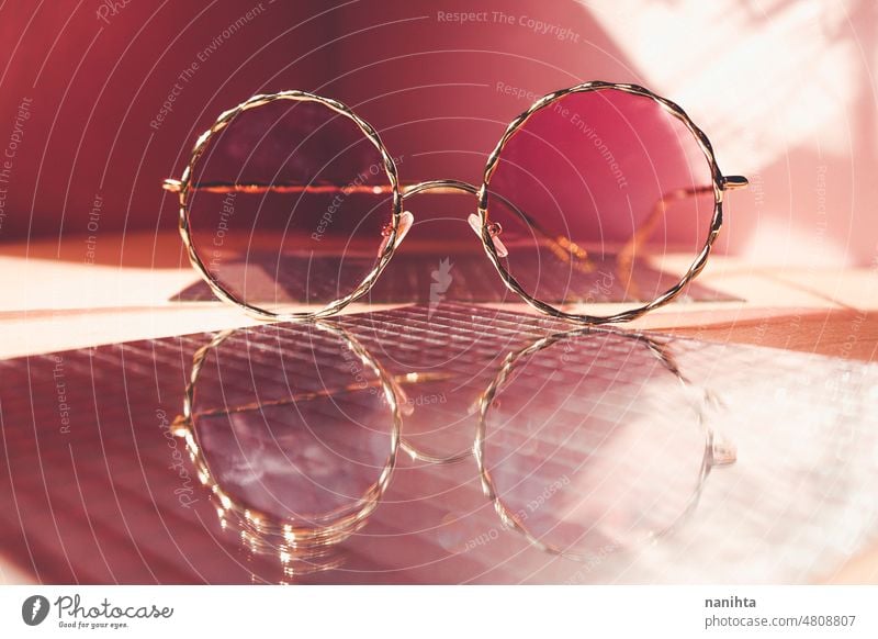 Studio shot of trendy female sunglasses in coral tones for summer fashion pink product still life mirror retro vintage reflection studio style golden stylish