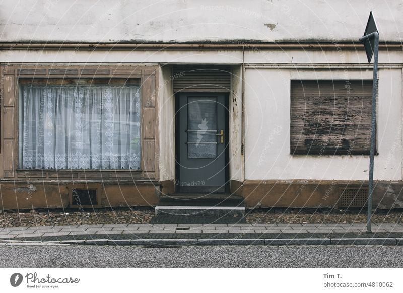 a store apartment in Lusatia Village Store premises shop apartment Lausitz forest Brandenburg Curtain Entrance Exterior shot Day Deserted Colour photo Closed