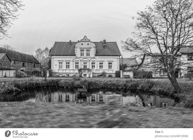 a manor house in Brandenburg Village bnw b/w Farmhouse village pond Black & white photo Day Exterior shot Deserted Architecture Building Old town Old building