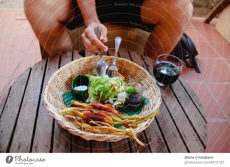 Tourist eating cambodian version of Lemongrass beef skewers or Bo Xa Nuong from Vietnam foodie food tourism lemongrass beef skewers bo xa nuong vietnamese food