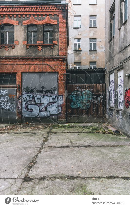 Backyard Prenzlauer Berg Berlin Colour photo Graffiti Town Exterior shot Day House (Residential Structure) Deserted Window Facade Old building Old town Downtown