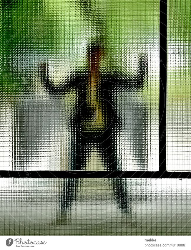 [hansa BER 2022] Jumping jack behind fluted glass pane Pane Window Window pane Transparent Vista hazy Human being Woman fax pose Sieg profit Winning pose Slice