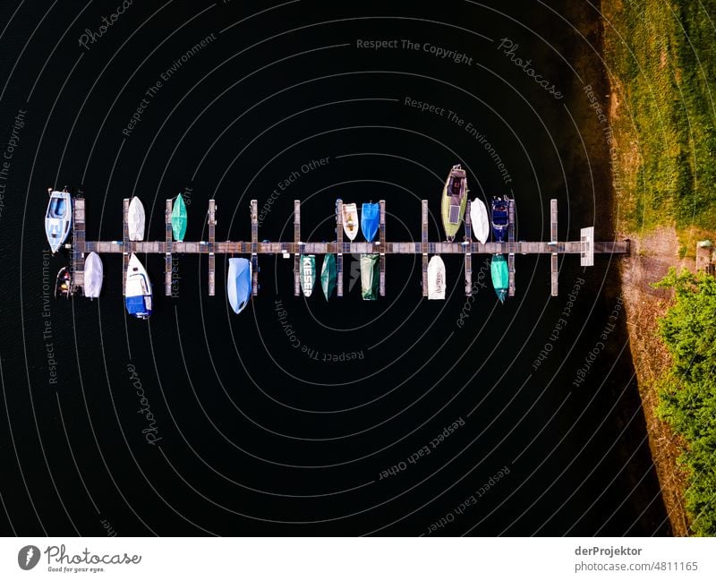 Pier with small boats photographed from above Colour photo Esthetic Hip & trendy ship Vacation & Travel Footbridge Trip Tourist Attraction Deserted