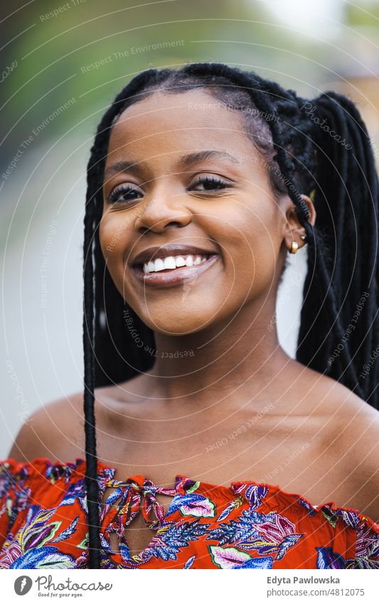 Portrait of a beautiful young woman outdoors cool carefree confident day millennials dreadlocks enjoy authentic positive real people joyful toothy smile