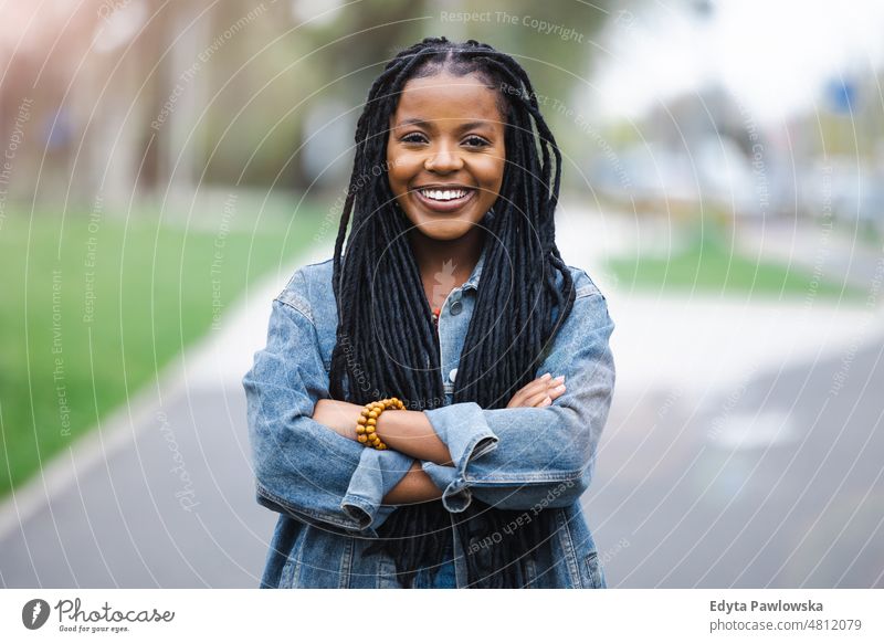 Portrait of a beautiful young woman in the city cool carefree confident day millennials dreadlocks enjoy authentic positive real people joyful toothy smile