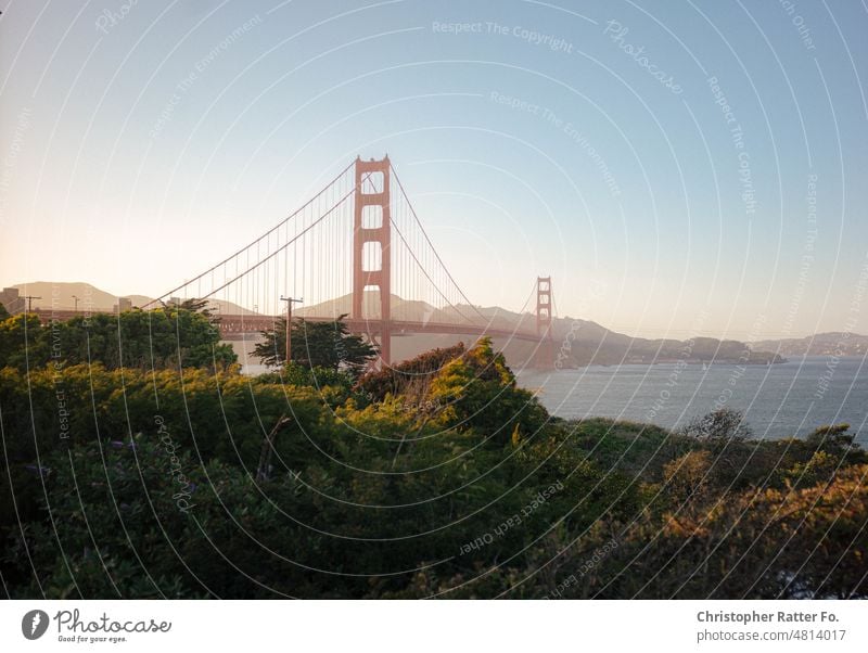 Iconic view of the Golden Gate Bridge at sunset. San Francisco, California. Sunlight Filmlook Tourism Landmark Twilight Light warm Federal elections Tourist Sky