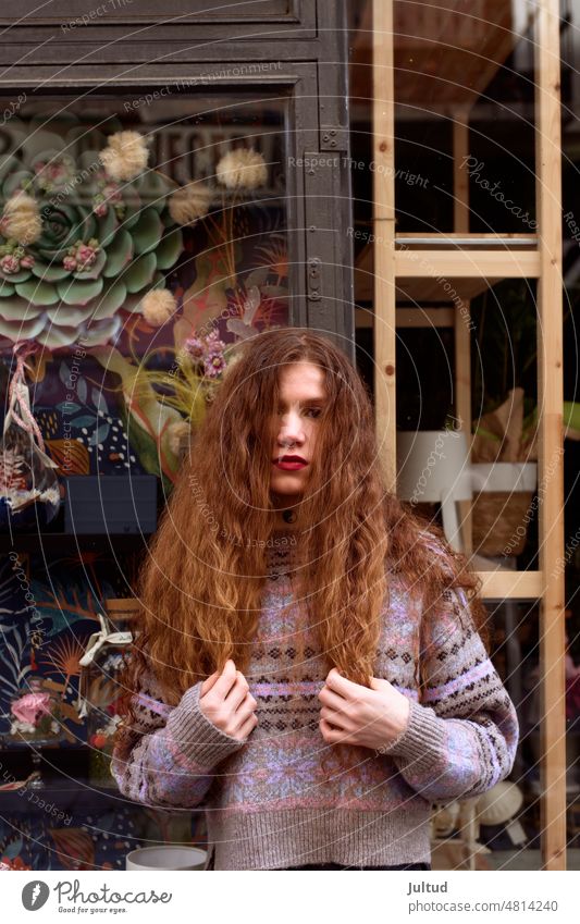 Portrait of young redheaded woman, on a city street natural girl naturally hair hairdressing hairstyle hairy lips lipstick red lips skin portrait