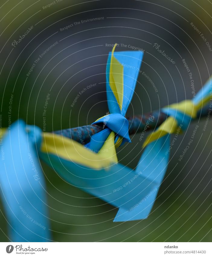 blue and yellow silk ribbon tied on a metal tube. Ukrainian flag symbol, struggle for independence ukraine ukrainian freedom national patriot patriotism country