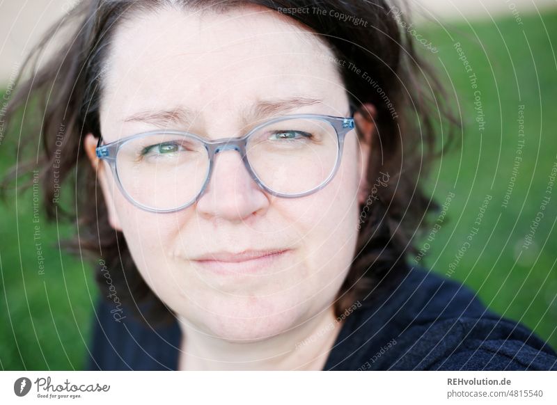 Woman looks critically into the camera Hair and hairstyles portrait Face Eyeglasses Human being Adults Looking into the camera blurriness 30 - 45 years Day