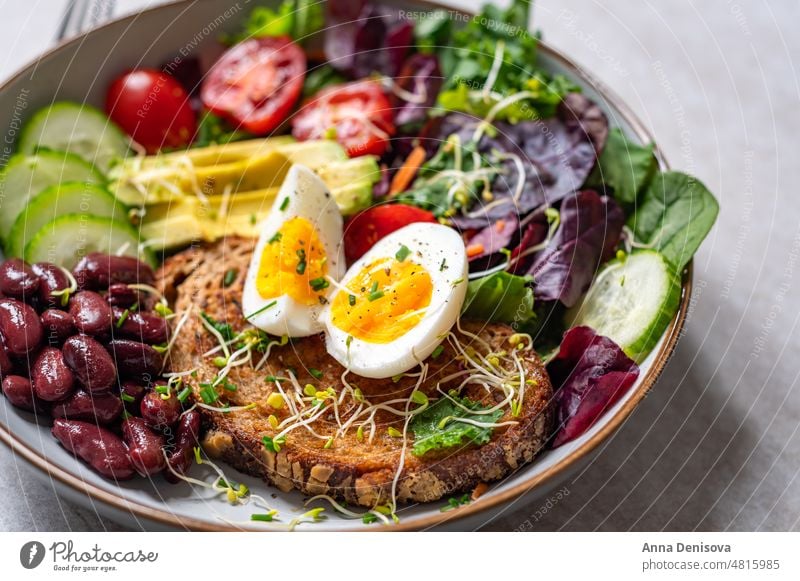 Medium boiled eggs with sasld, healthy breakfast soft-boiled diet bread yolk yellow medium boiled egg toast green salad leaves avocado cherry tomatoes cucumber