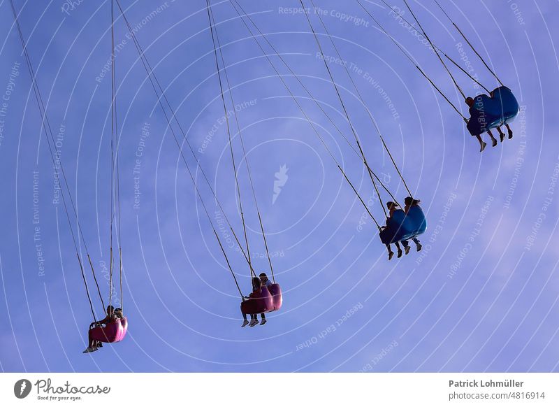 hanging section Carousel Fairs & Carnivals hustle and bustle Sky people People persons Hang gondola Germany Europe fun Joy free time pleasure entertainment