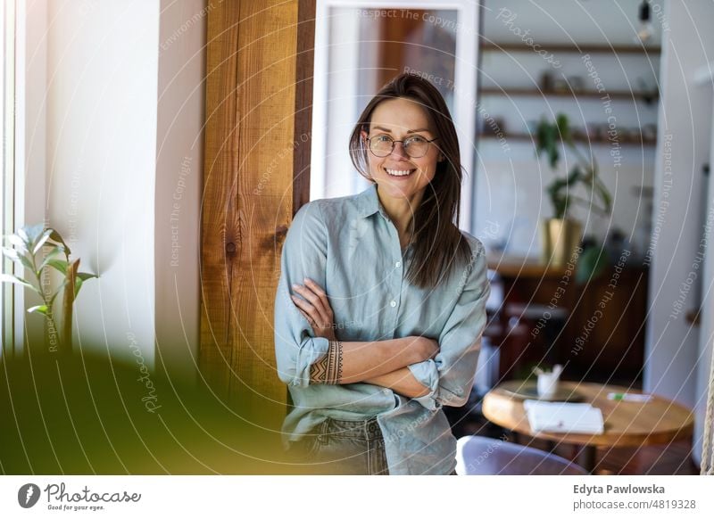 Portrait of a young woman standing in her home domestic life confidence indoors house people adult casual female Caucasian attractive beautiful tattoos one