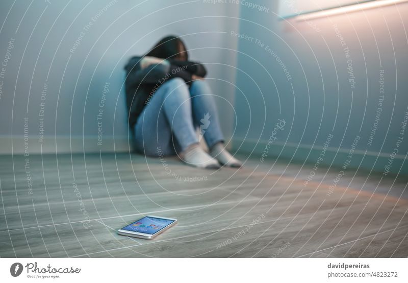 Unrecognizable woman covering her face desperate for cyberbullying unrecognizable covering face mobile anxiety smartphone copy space harassment female internet