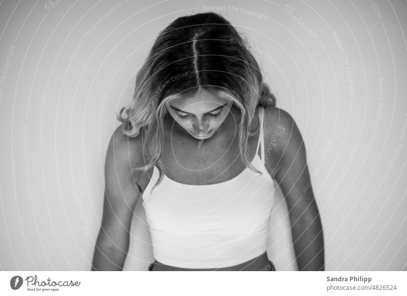 Portrait of a young woman in white top. View averted from camera portrait Woman Looking Long-haired Feminine Face Meditative pretty feminine Self-confident