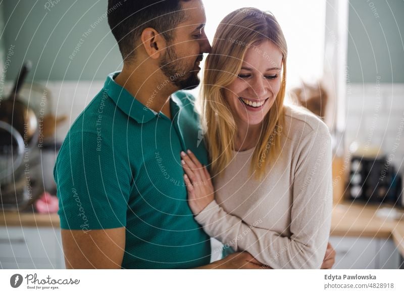 Young couple in love hugging at home morning kitchen husband wife lovers emotions romance attractive two beautiful romantic embracing adult boyfriend candid