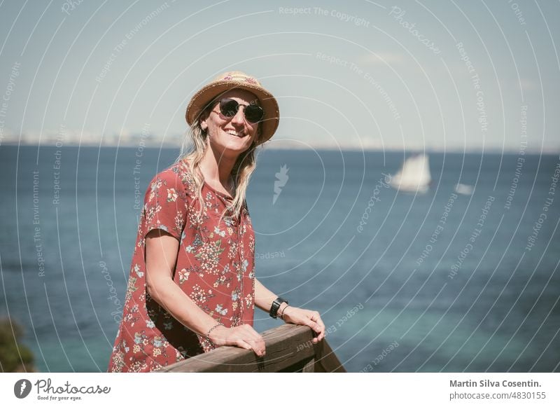 Blonde Woman in the Algarve, Portugal in the summer of 2022. algarve architecture atlantic bay beach blue boat boats building city cliff coast coastline