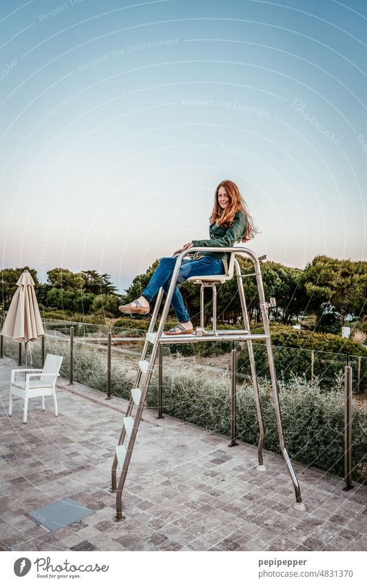 redhead woman sitting on high lifeguard supervision chair Pool attendant Lifeguard Vacation & Travel pool Swimming pool Swimming & Bathing Summer Colour photo