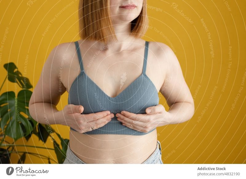 Crop young redhead lady practicing yoga in yellow studio woman breath wellbeing stress relief zen practice healthy lifestyle calm mindfulness wellness female