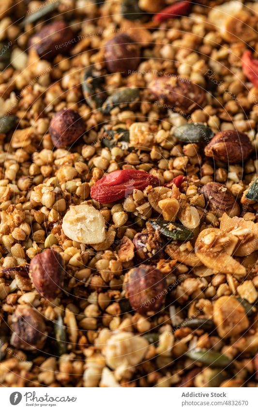 Close-up view of granola red berries muesli nuts seeds goji breakfast rustic healthy oat dessert food diet snack cereal fresh nutrition natural homemade grain