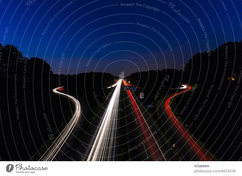 interchange at night with lighttrails motorway junction highway crossing aachen dawn auto freeway movement light-trail transportation logistics traffic sunrise