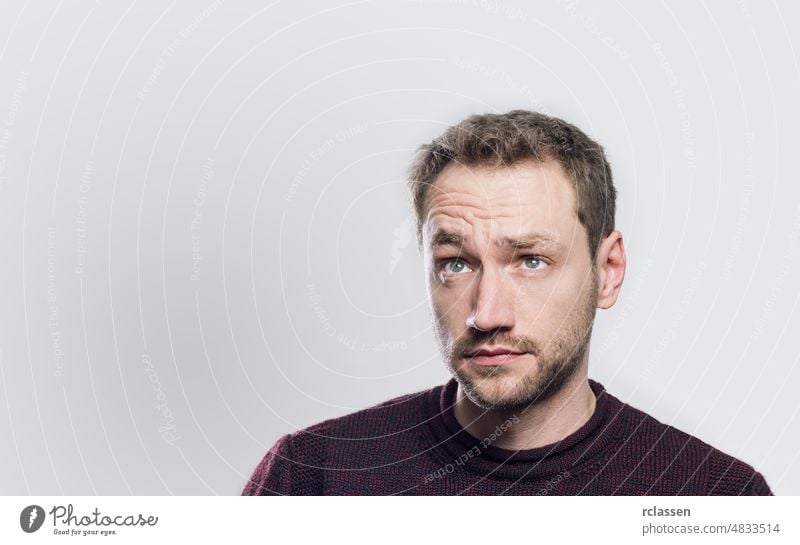 surprised young man looking up think face planning pensive beard expression amazed person hipster thoughts wow doubt mouth idea thought bubble college student