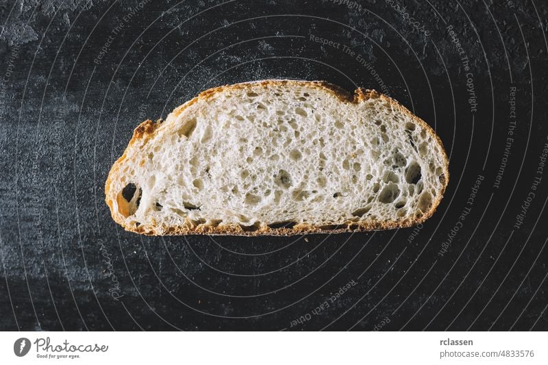 bread slice on dark background top view wooden table directly above rye bake rustic fresh food brown organic agricultural agriculture bakery breakfast crust cut