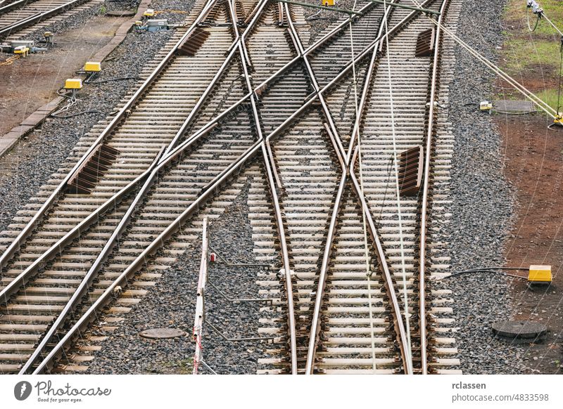 Train tracks with many options for ways forward with multiple switch point train railroad line journey path directions speed background horizon iron steel dusk