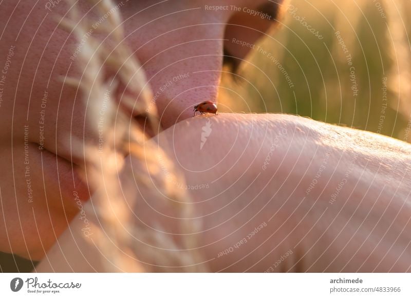 Woman playing with ladybug outdoors CONSCIENCE adventure animal anonymous awareness care close up cute delicate detail earth enjoy environment everyday explore