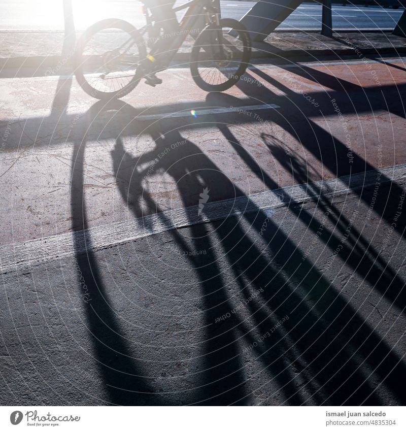 cyclist on the street, mode of transportation in the city, bilbao, spain biker bicycle cycling biking exercise activity lifestyle ride speed fast shadow