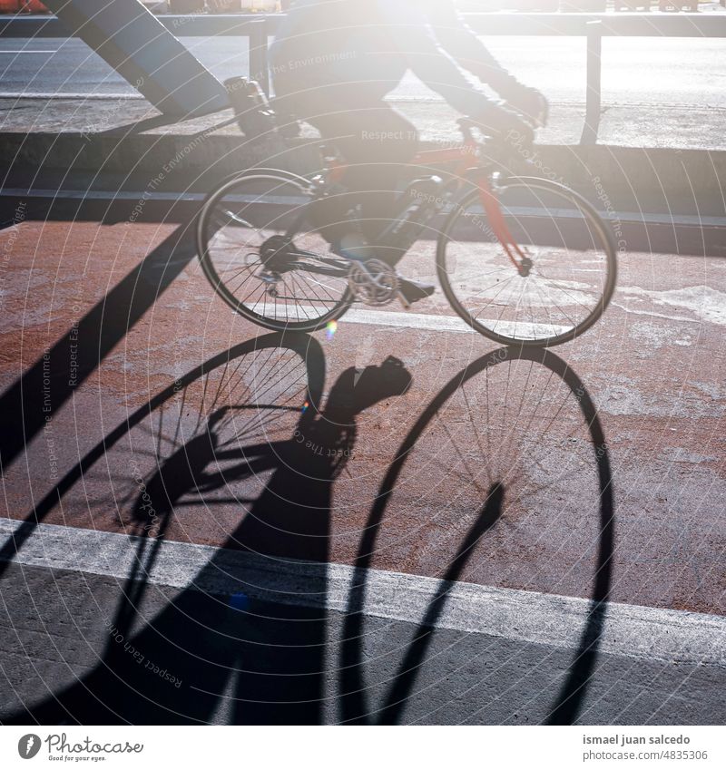 cyclist on the street in Bilbao city, spain, mode of transportation biker bicycle cycling biking exercise activity lifestyle ride speed fast shadow silhouette