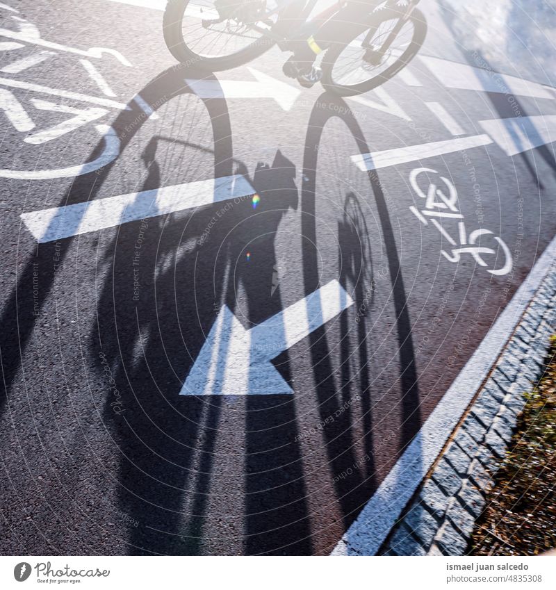 cyclist on the street, mode of transportation biker bicycle cycling biking exercise activity lifestyle ride speed fast shadow silhouette city road urban