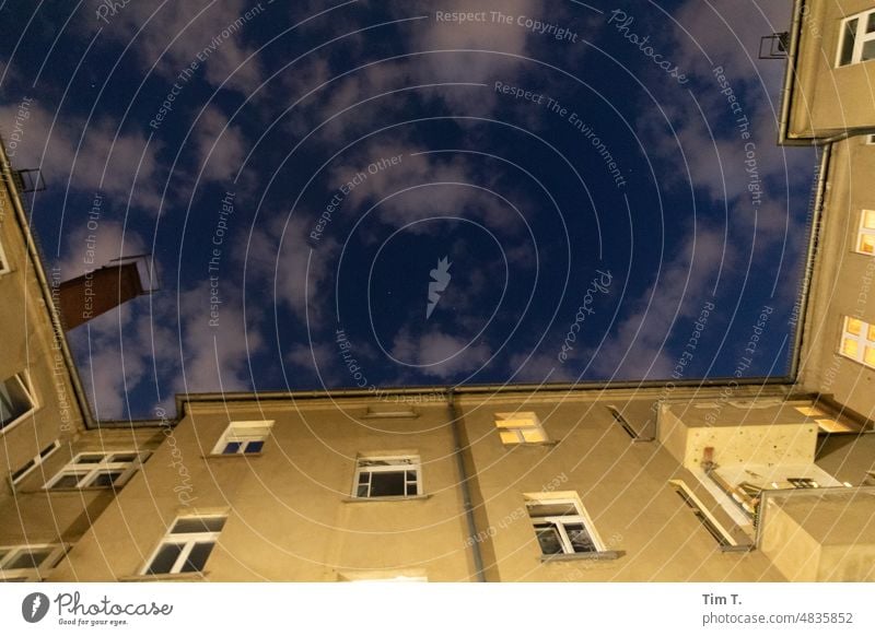 Night sky over a Berlin backyard Backyard Clouds Colour photo House (Residential Structure) Window Sky Town house (City: Block of flats) Light Facade Courtyard