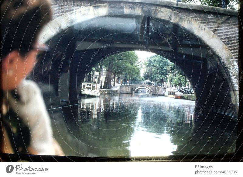 View of the Canal from Under the Bridge in Amsterdam, Netherlands Unique Perceptive Boat Holland Vacation & Travel Beautiful Outdoors On the Water Tourism