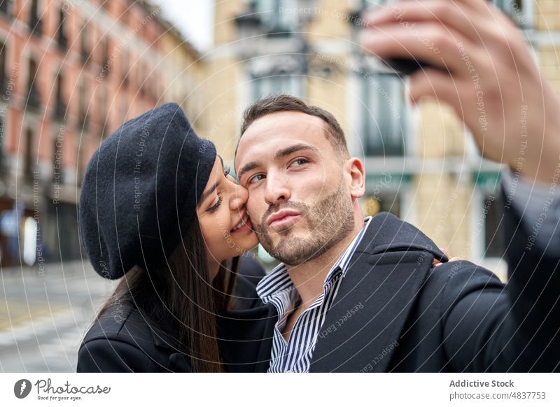 Loving couple taking selfie on street love relationship fondness date romantic kiss caress self portrait capture memory tender city bonding spend time woman