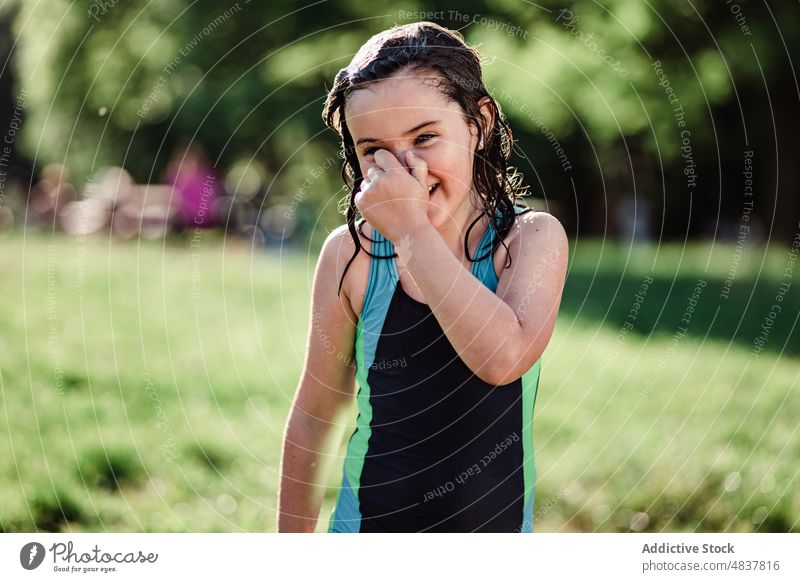 Wet girl smiling in park summer female wet meadow nature sportswoman happy healthy droplets positive lawn cheerful relax lifestyle rest smile blurred background