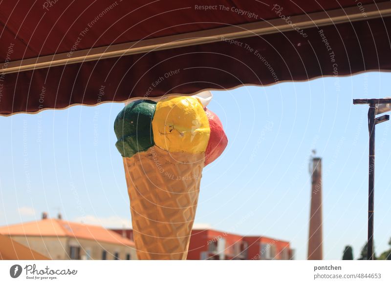 Awning and stand ice cream cone with ice cream scoops. Ice cream parlor. Advertising Ice-cream parlor Sun blind display Ice-cream cone Ice cream ball Pistachio