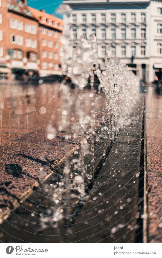 Fountain on a market place Water Drops of water Water fountain Wet Bubbling Inject Fresh Cold Refreshment Marketplace Town Summer cooling Sunlight Downtown