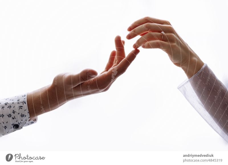 Concept of human relation, community, togetherness, teamwork, love, symbolism, culture and history. Hand of male and female reaching to each other. People relationship. Selective focus.