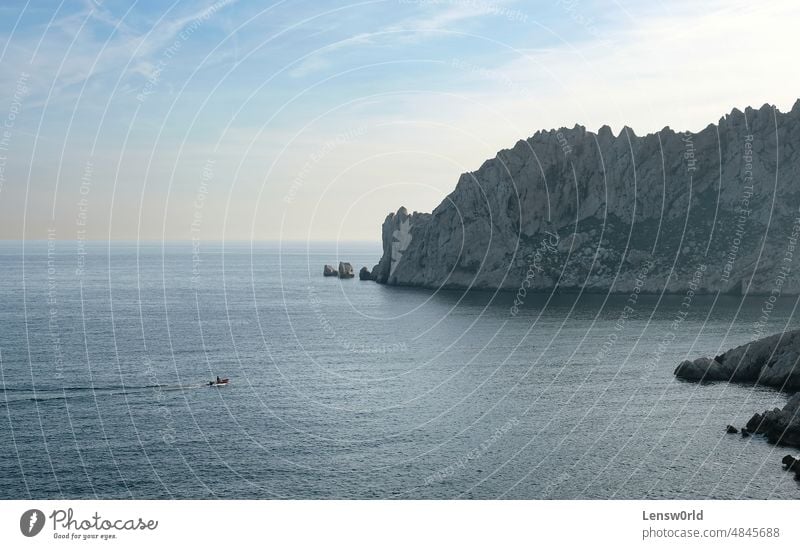 Boat going in the coastal scenery outside of Marseille, France bay blue cliff cliffs coastline cote azure côte d'azur horizon landscape marseille mediterranean