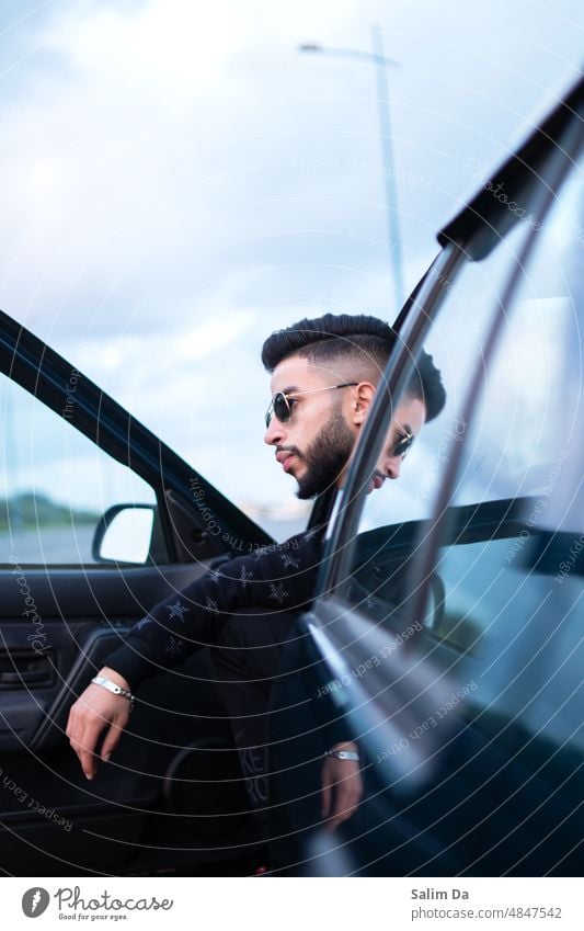 Stylish portrait of a young handsome male Style stylish Sunglasses trendy Modern modern lifestyle Man Beard bearded Bearded man photogenic Looking Looking away