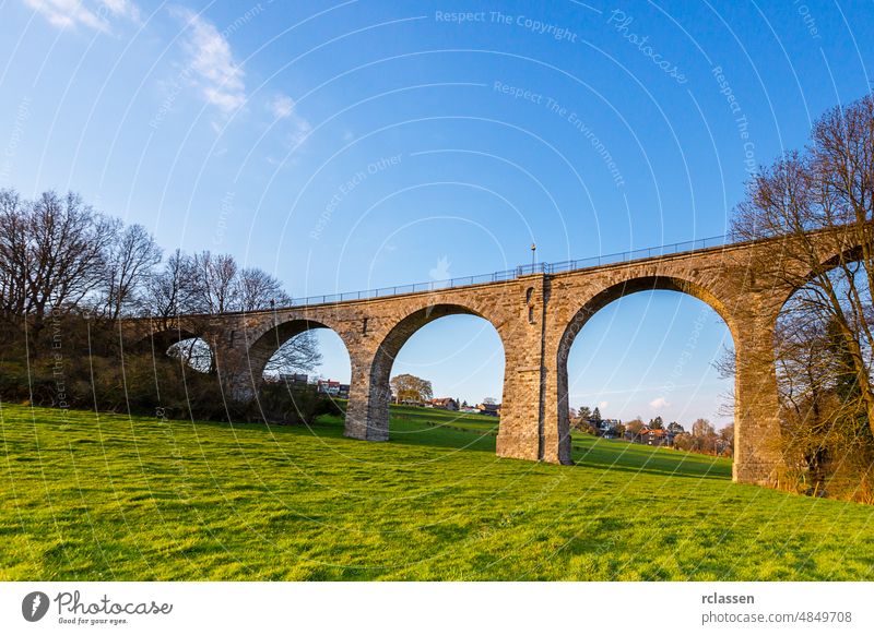 Vennbahn viaduct in aachen at srping venntrain railroad track Railway line Aachen bridge spring sky building pylon old sunset stones tourist Vennbahnweg away