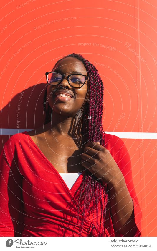 Cheerful black woman in trendy outfit portrait african american style red female modern confident fashion urban happy cheerful smile model elegant street bright