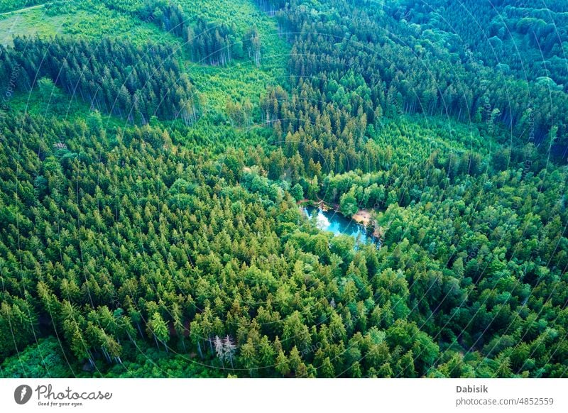 Aerial view of blue colored forest lake in Poland blue lake aerial green pond colorful poland above top water heart wild recreation mountain background