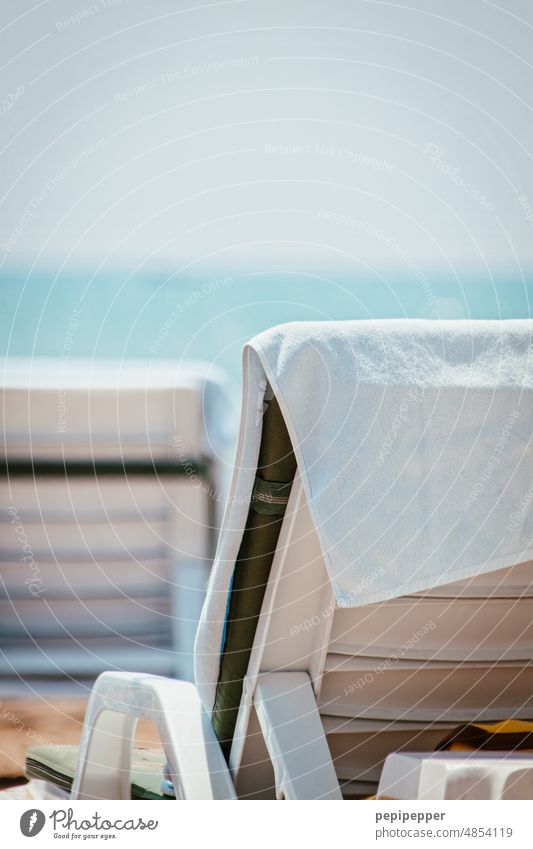 Bath towel on a lounger on the beach Towel Couch Deckchair sun lounger Beach Vacation & Travel Relaxation Summer Ocean Summer vacation Tourism Exterior shot