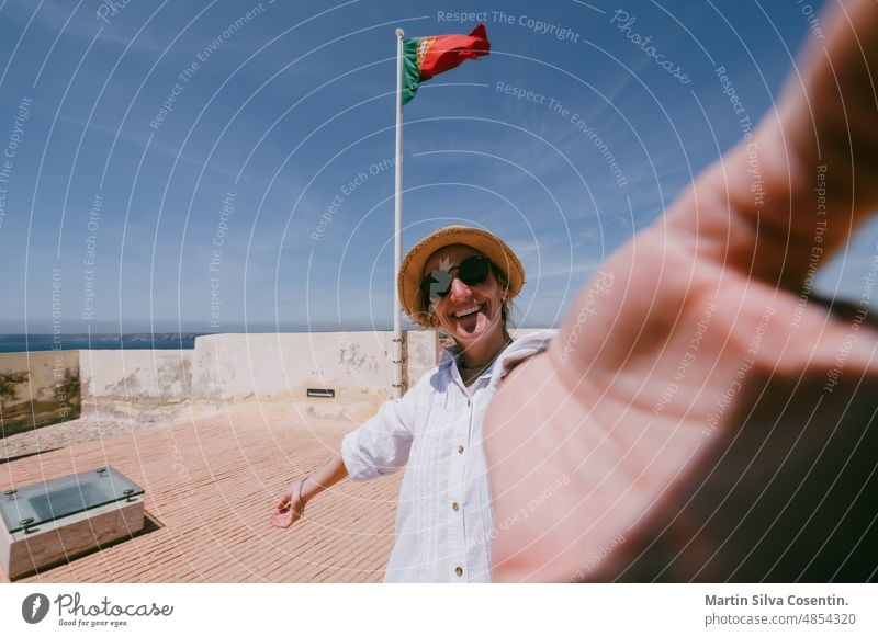 Young Blonde woman the Fortaleza de Sangre in the Algarve, Portugal in summer algarve ancient architecture atlantic beach beautiful blue building cannon cape