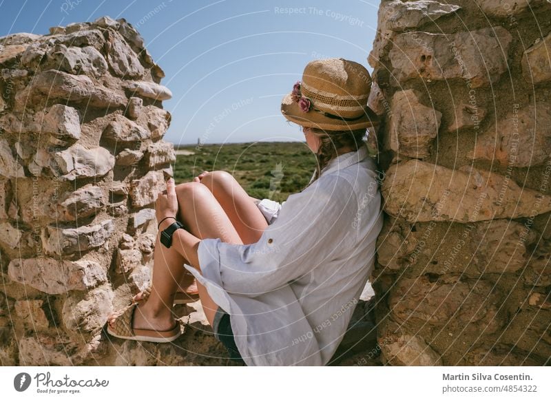 Young Blonde woman the Fortaleza de Sangre in the Algarve, Portugal in summer algarve ancient architecture atlantic beach beautiful blue building cannon cape