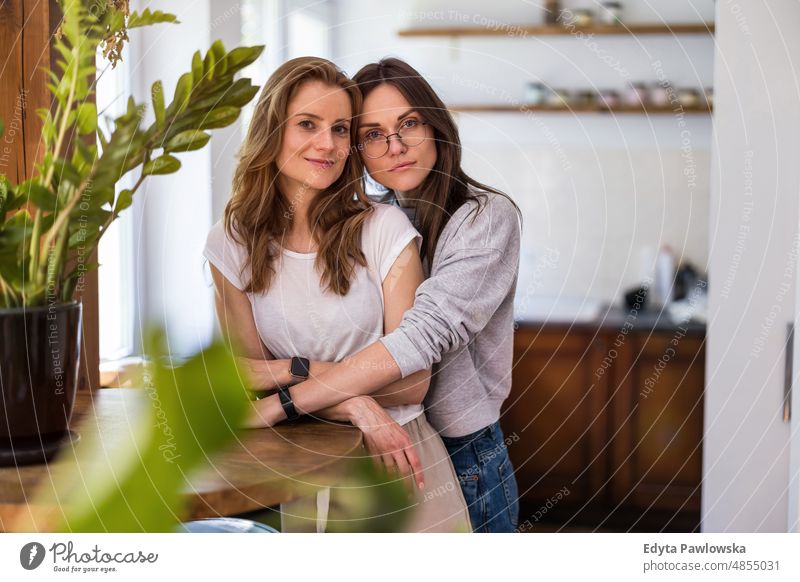 Portrait of affectionate lesbian couple embracing at home same sex couple adult apartment attractive beautiful bonding dating couple enjoyment family female