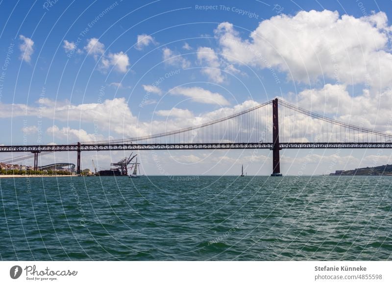 Ponte 25 de Abril in Lisbon Blue Steel Construction Bridge piers Ocean colourful Tejo Tejo Bridge travel Portugal Vacation & Travel Tourism City trip