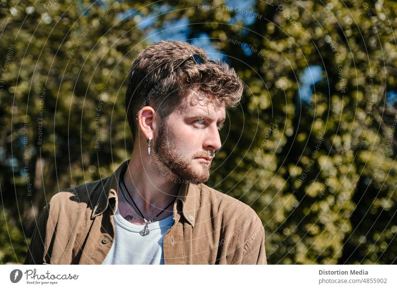 Portrait of a trendy boy with an intense expression on a forest facial expressions lifestyle professional gentleman caucasian casual attractive attitude